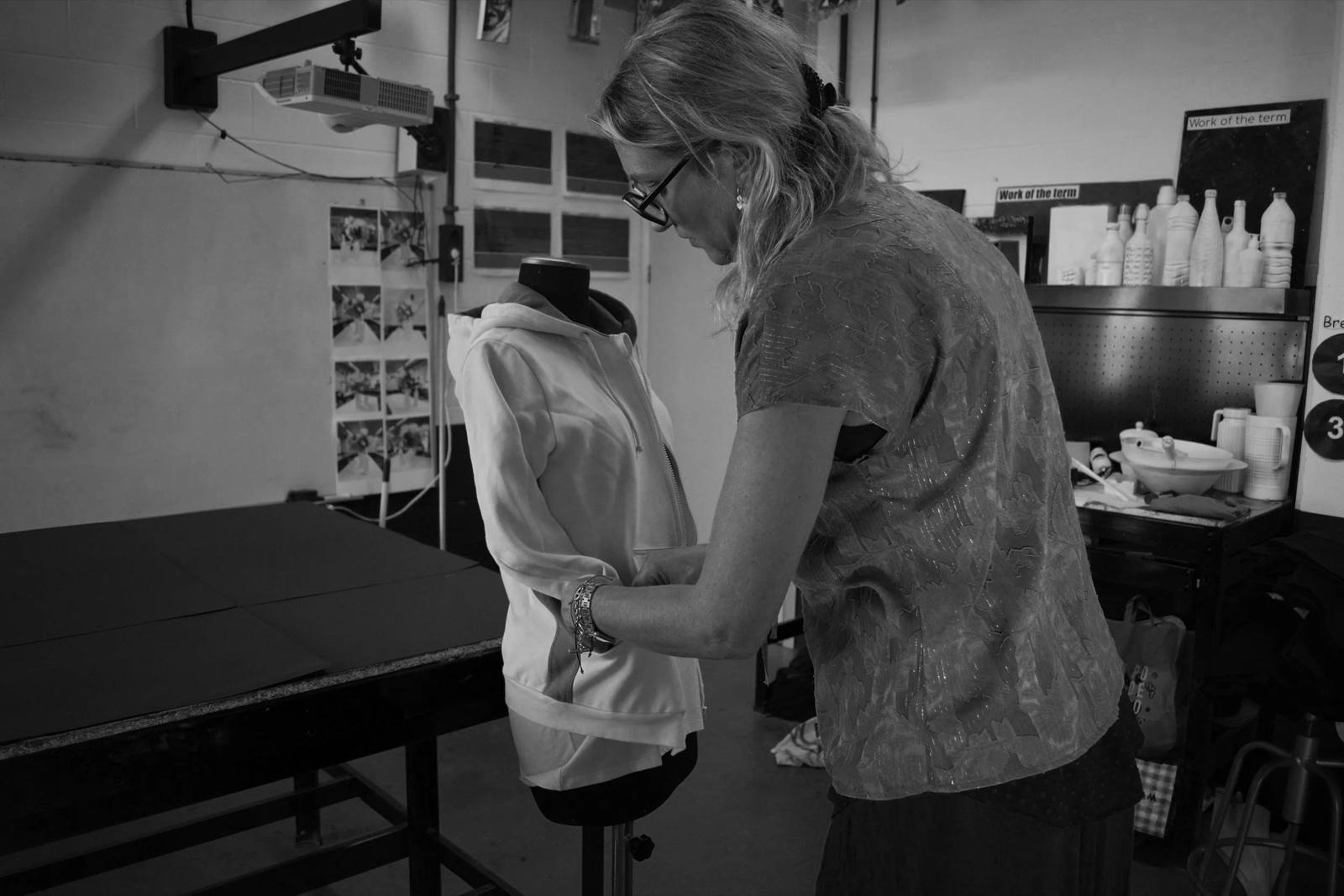 Anne-Claire Albregts fitting a hooded garment on a dress form in a design studio